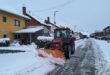 Traktor s ralicom čisti snijeg na ulici tokom zimskih uslova.